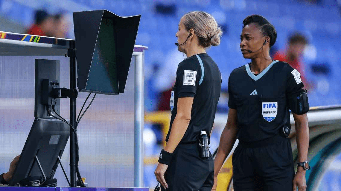 Referee Ivana Martincic reviews an incident after a challenge made by a coach during the FIFA U20 Women's World Cup semifinal between United States and North Korea in Cali, Colombia