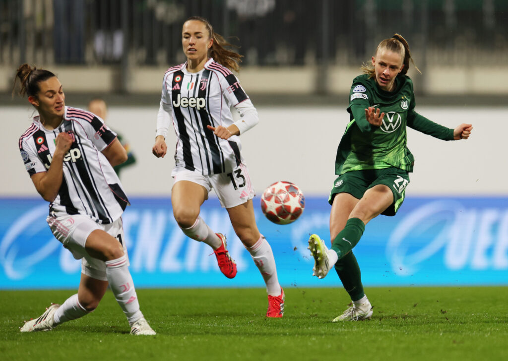 WOLFSBURG, GERMANY - FEBRUARY 12: Vivien Endemann of VfL Wolfsburg shoots past Martina Lenzini and Lia Walti of Juventus during the UEFA Women's Champions League 2025/26 KO play-offs First Leg match between VfL Wolfsburg and Juventus at Wolfsburg Stadion on February 12, 2026 in Wolfsburg, Germany. (Photo by Boris Streubel - UEFA/UEFA via Getty Images)