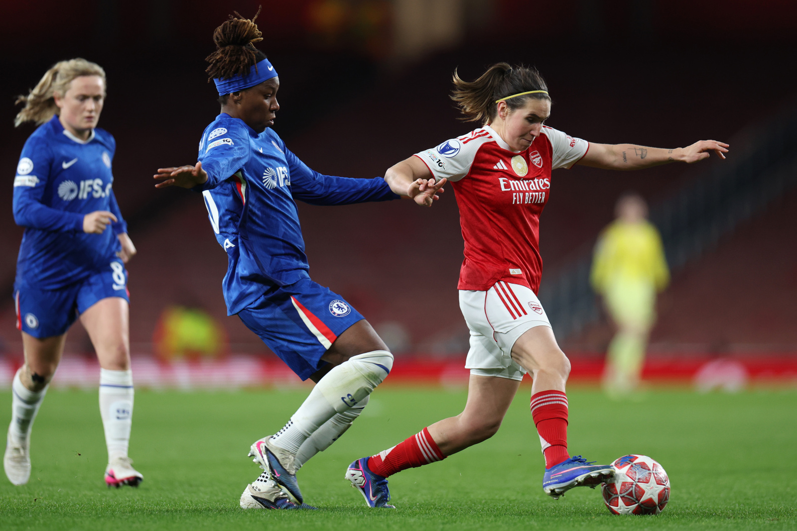 Mariona Caldentey of Arsenal is challenged by Kadeisha Buchanan of Chelsea during the UEFA Women's Champions League 2025/26 Quarter-finals First Leg match between Arsenal and Chelsea at Arsenal Stadium