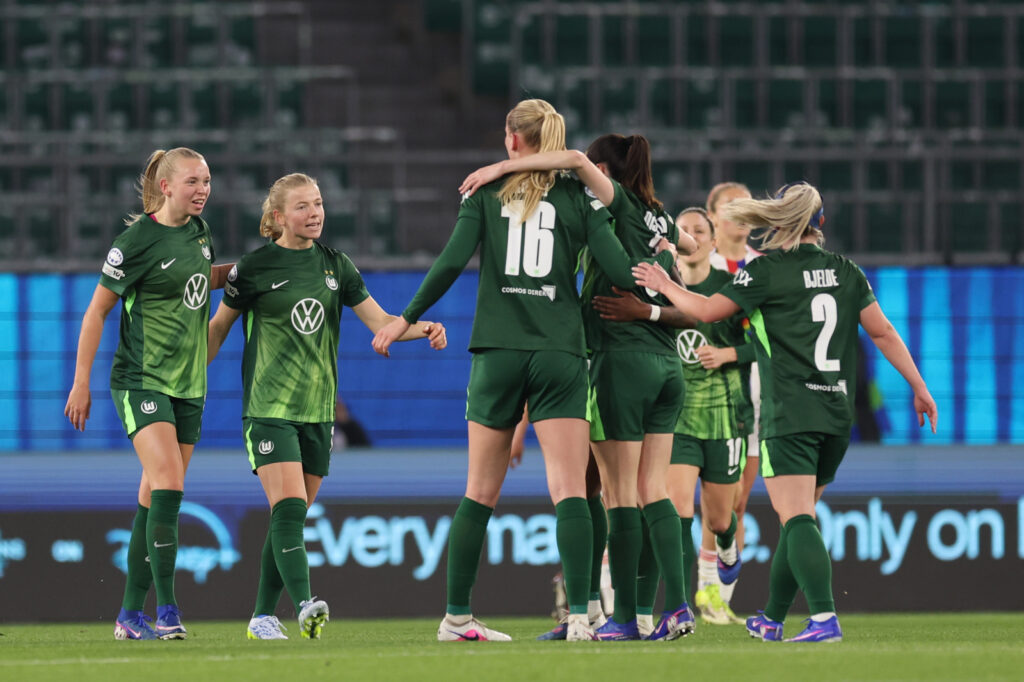 WOLFSBURG, GERMANY - MARCH 24: VfL Wolfsburg players celebrate their team's first goal scored by teammate Lineth Beerensteyn (obscured) during the UEFA Women's Champions League 2025/26 Quarter-finals First Leg match between VfL Wolfsburg and OL Lyonnes at VfL-Stadion am Elsterweg on March 24, 2026 in Wolfsburg, Germany. (Photo by Boris Streubel - UEFA/UEFA via Getty Images)