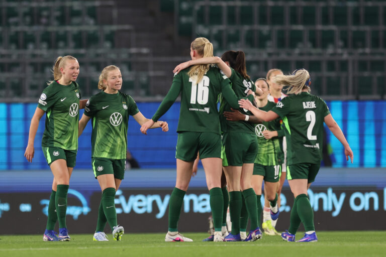 WOLFSBURG, GERMANY - MARCH 24: VfL Wolfsburg players celebrate their team's first goal scored by teammate Lineth Beerensteyn (obscured) during the UEFA Women's Champions League 2025/26 Quarter-finals First Leg match between VfL Wolfsburg and OL Lyonnes at VfL-Stadion am Elsterweg on March 24, 2026 in Wolfsburg, Germany. (Photo by Boris Streubel - UEFA/UEFA via Getty Images)