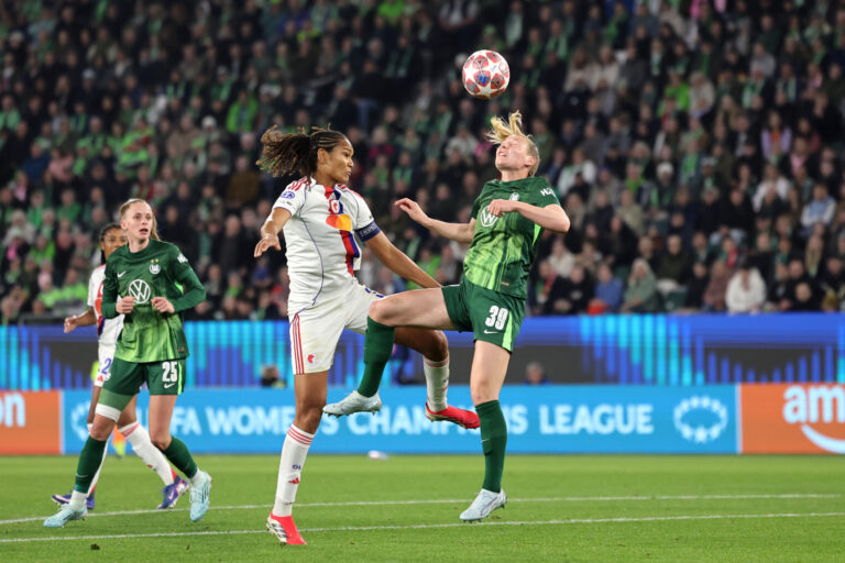 WOLFSBURG, GERMANY - MARCH 24: Sarai Linder of VfL Wolfsburg wins a header against Wendie Renard of OL Lyonnes during the UEFA Women's Champions League 2025/26 Quarter-finals First Leg match between VfL Wolfsburg and OL Lyonnes at VfL-Stadion am Elsterweg on March 24, 2026 in Wolfsburg, Germany. (Photo by Boris Streubel - UEFA/UEFA via Getty Images)