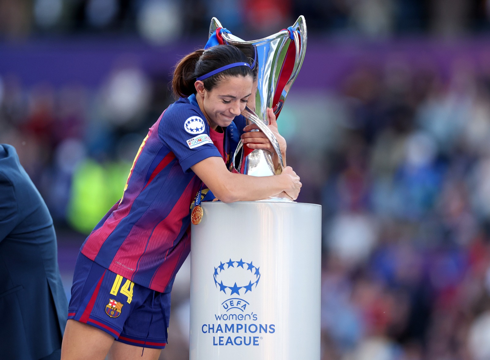 OSLO, NORWAY - MAY 23: Aitana Bonmati of FC Barcelona embraces the UEFA Women's Champions League Trophy following the team's victory during the UEFA Women's Champions League Final 2026 match between FC Barcelona and OL Lyonnes at Ullevaal Stadion on May 23, 2026 in Oslo, Norway. (Photo by Florencia Tan Jun - UEFA/UEFA via Getty Images)